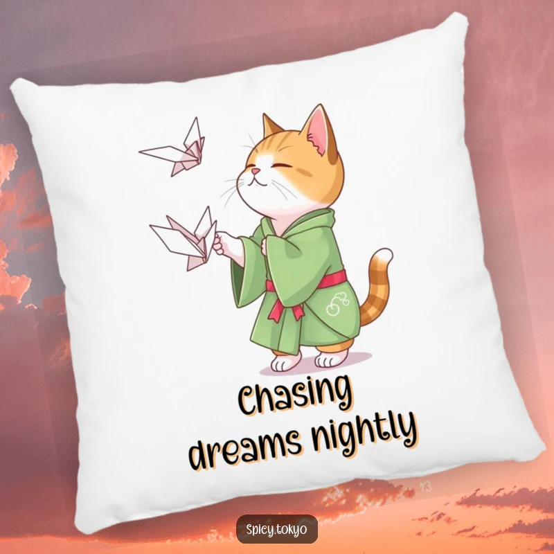 Funny cat in a green kimono playfully attempting to catch a floating origami crane, a soft and humorous pillow.